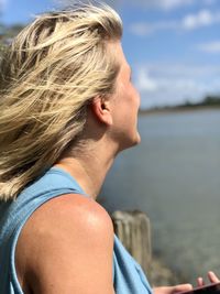 Portrait of woman with sea in background