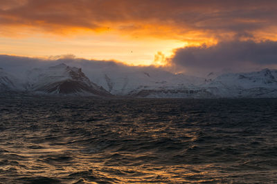 Scenic view of snowcapped mountains against sky during sunset