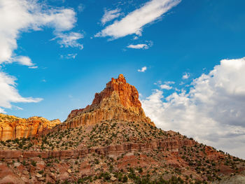 Low angle view of rock formations against sky