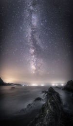 Scenic view of sea against clear sky at night