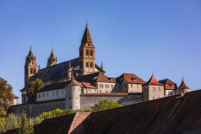 Low angle view of buildings against clear blue sky