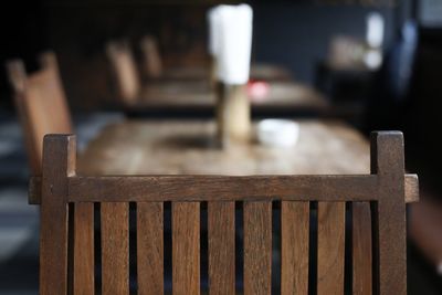 Close-up of empty chairs at table