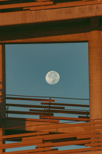 Low angle view of moon against blue sky