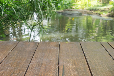 Surface level of wooden bench by lake