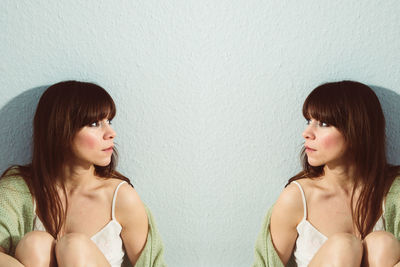Multiple image of woman sitting against wall
