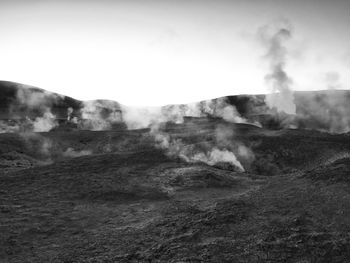 Smoke emitting from volcanic mountain against sky