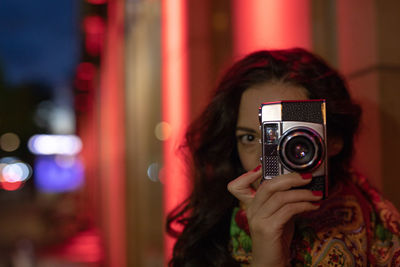 Beautiful woman photographing outdoors