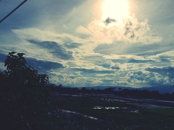 Scenic view of field against sky at sunset