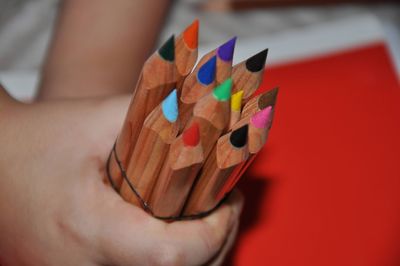 Cropped hand of woman holding pencil