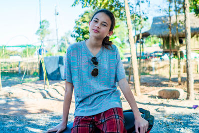 Portrait of young woman standing in lake