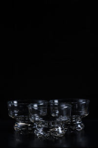 Glass bowls against black background