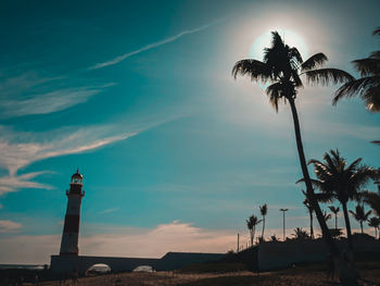 Low angle view of silhouette palm trees against sky