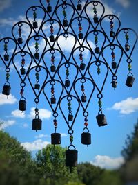 Low angle view of decorations hanging on building against sky