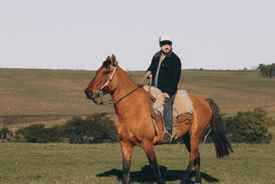 Man riding horse on field