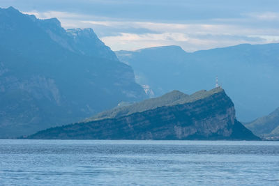 Scenic view of sea and mountains against sky