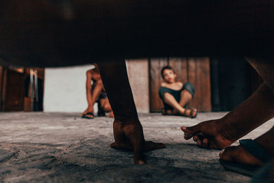 Low section of people sitting on floor