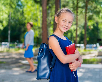 Portrait of smiling girl holding camera