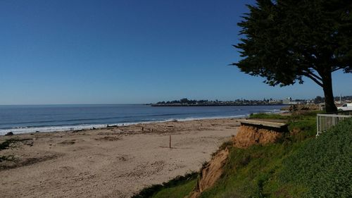 Scenic view of beach against clear blue sky