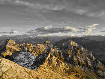 Scenic view of mountain range against cloudy sky