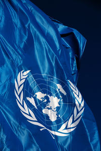 Close-up of united nations flag against black background