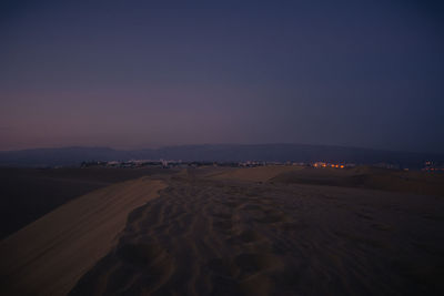 Scenic view of desert against sky at night