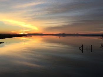 Scenic view of lake at sunset