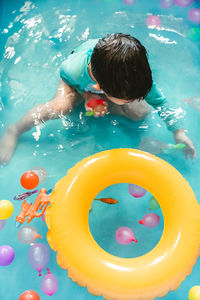 High angle view of boy swimming in pool