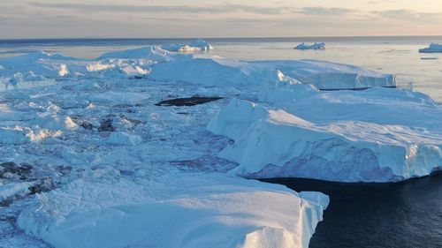 Scenic view of frozen sea against sky