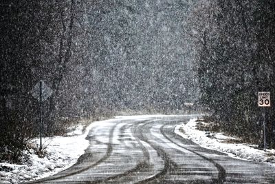 Road passing through snow covered landscape