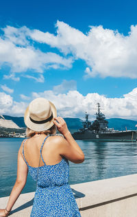 Rear view of woman looking at sea against sky