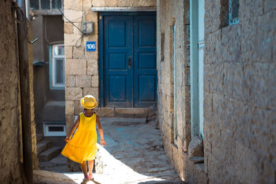 Rear view of woman walking on street