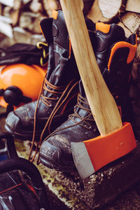 Close-up of boots and axe on table