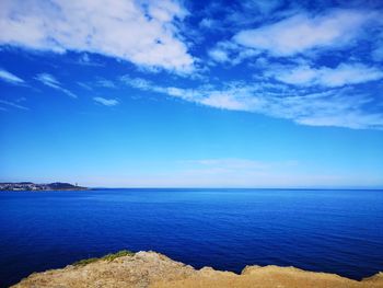 Scenic view of sea against blue sky