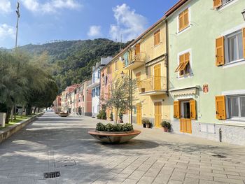 Street amidst buildings in city against sky