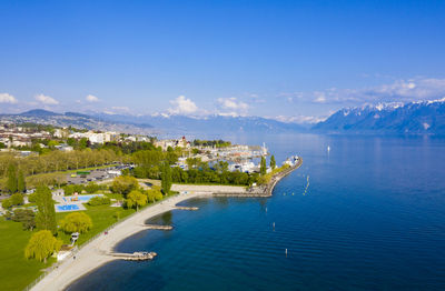 High angle view of townscape by sea against sky
