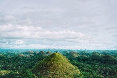 Scenic view of mountains against cloudy sky