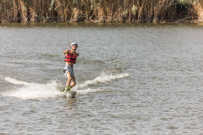 Full length of man surfing in sea