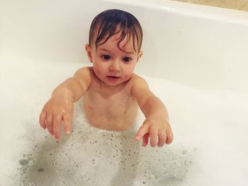 High angle view of cute baby girl in bathtub