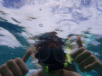 Close-up of man wearing scuba mask swimming