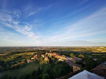 Aerial view of houses and trees against sky