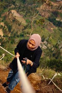 High angle view of young woman hiking