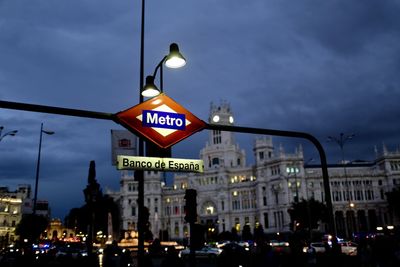 Information sign on road at dusk