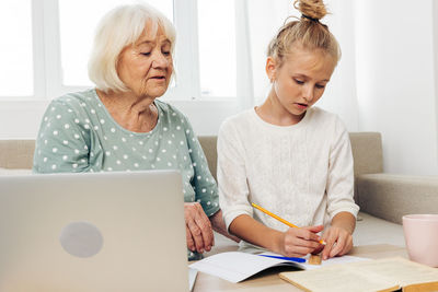 Young woman using laptop at home