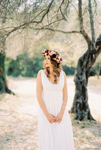 Rear view of woman standing against trees