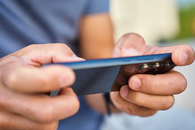 Midsection of man using mobile phone