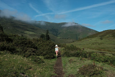 Man standing on mountain against sky