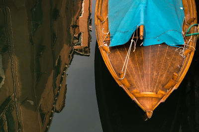 High angle view of reflection by boat moored in river