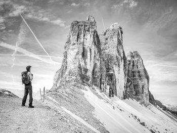 Backpacker on trip aound tre cime di lavaredo in sunny april morning. view from tour around massive