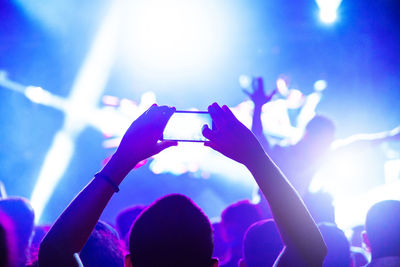 Rear view of people enjoying at music concert