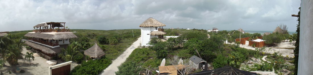 Panoramic view of castle and houses against sky